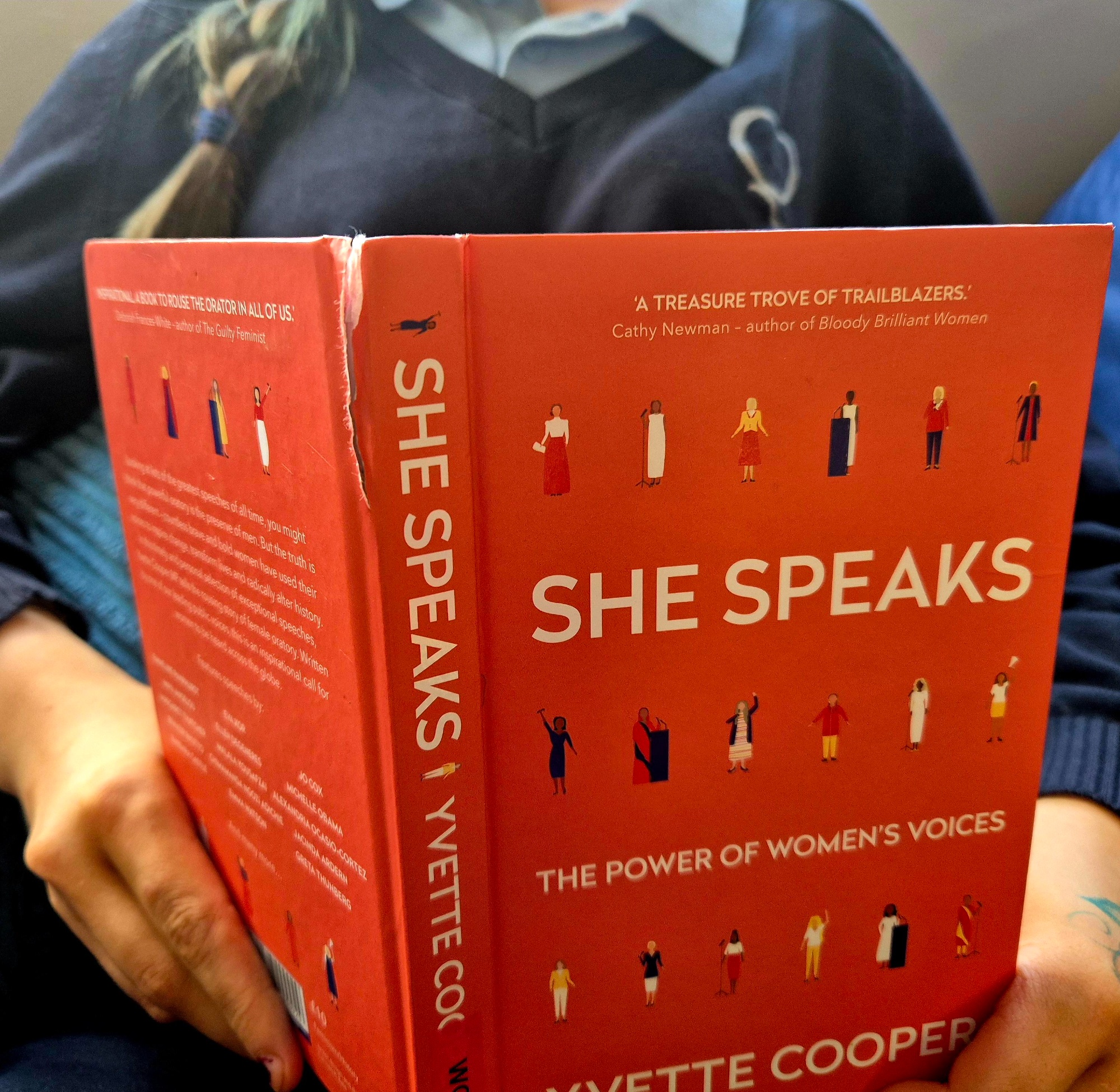 female reading a book about representation